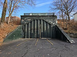 Iron gate blocking the historic brick eastern portal of the East Side Railroad Tunnel