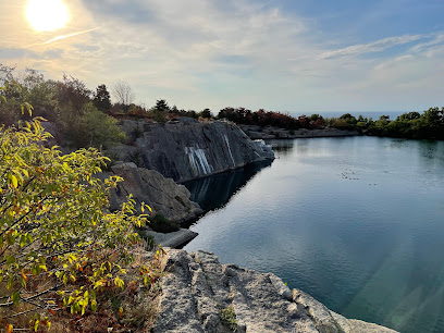 Halibut Point water filled granite quarry and crashing coastal ocean ledges