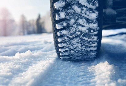 Deep tread winter snow tires tracking through heavy lake-effect slush